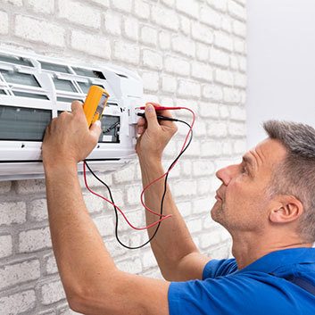 A technician working on an air conditioner